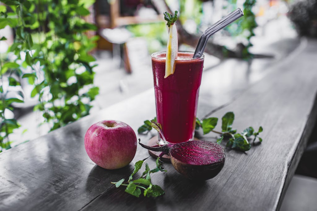 Refreshing beetroot and apple juice garnished with mint leaves, perfect for a healthy detox.