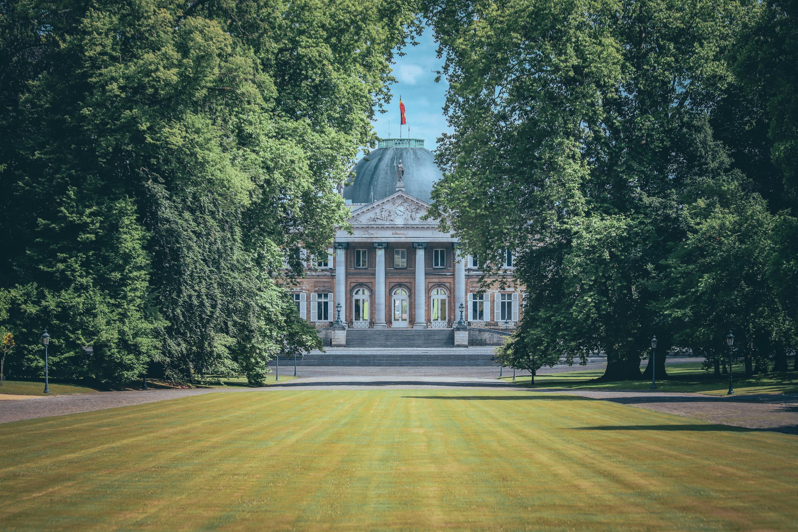 View of the Royal Palace of Laeken amidst lush gardens in Brussels, Belgium.